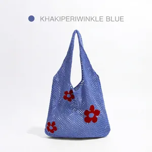 Periwinkle blue hollow knit tote bag with red flower patterns on a white background