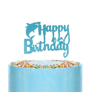 Close-up of light blue shark Happy Birthday cake topper with sparkling glitter finish