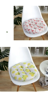 Detail view of round chair cushions with flamingo and lemon patterns on Nordic chairs