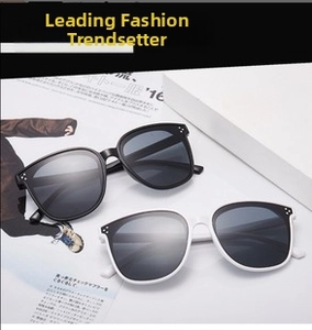 Detail of pilot-style sunglasses with large frames and decorative silver rivets on the sides