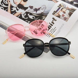 Detail of vintage pilot sunglasses with gold metal temple tips on a fashion magazine