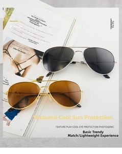 Detail showing two pairs of classic aviator sunglasses with silver and gold metal frames
