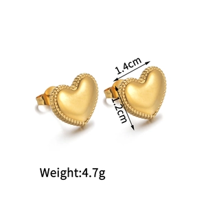 Detail view of 18K gold heart earrings showing 1.4cm width and matte finish texture