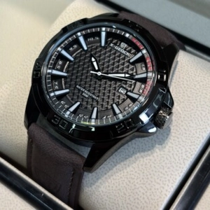 Macro shot of men's matte black quartz watch with luminous hands and date window