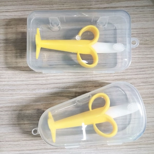 Detail of two silicone banana teethers with white bristles and clear storage cases