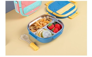 Three-compartment stainless steel lunch box showing fresh pasta and fruit portions