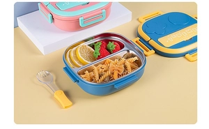 Detail of 304 stainless steel lunch box interior with compartments and small fork
