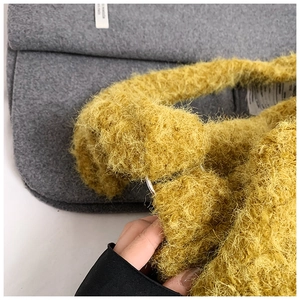 Close-up of mustard yellow plush tote bag showing soft texture and metal buckle detail