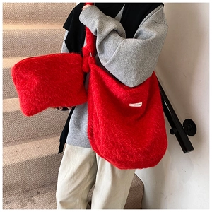 Detail of red plush tote bag and matching pouch showing soft faux fur texture and size