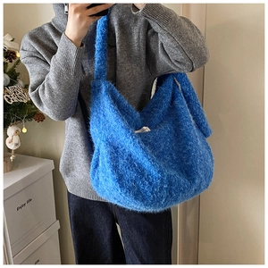 Close-up of fluffy bright blue faux fur tote bag showing plush texture and large capacity