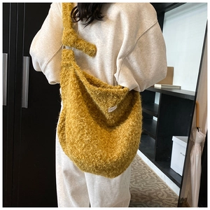 Detail of ginger plush hobo bag with soft faux fur texture and knotted strap design
