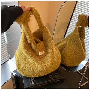 Detail of mustard yellow plush tote bag with knot handle and white fabric label