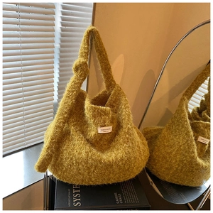 Detailed view of ginger plush shoulder bag showing fuzzy texture and knot handle detail