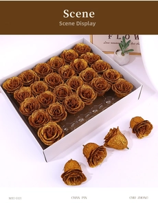 Detailed view of artificial gold glitter rose heads in a 25-piece bulk display box