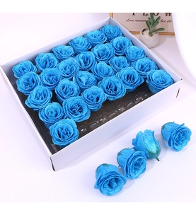 Detail of handmade blue glitter soap roses in white cardboard gift box arrangement