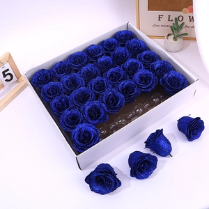 Set of 25 blue glitter artificial rose heads for DIY crafts on a clean white background