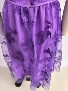 Detail of purple tulle dress showing exquisite 3D butterfly embroidery and floral patterns