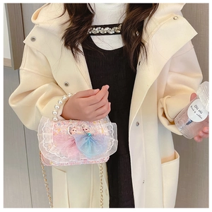 Detail of pink tweed girl's bag with pearl handle, lace trim and princess design