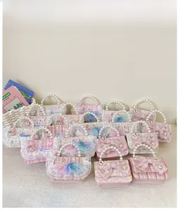 Detail of pink tweed princess handbags with pearl handles and bow accents for girls