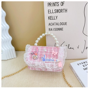 Macro detail of StellaLou pink tweed handbag with pearl handle and lace edging decoration