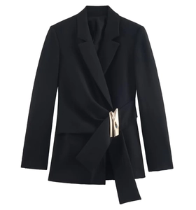 Detail of black women's suit jacket featuring asymmetrical waist with gold metal buckle