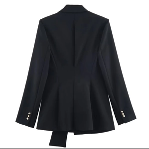 Back view of slim fit black blazer featuring gold decorative buttons on the cuffs