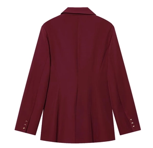 Detail view of burgundy blazer back with tailored waistline and gold cuff buttons