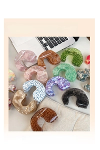 Variety of colorful acetate hair claw clips with marble and floral patterns on white background