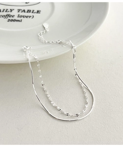 Close-up of S925 sterling silver double-layer snake chain with shimmering sequins