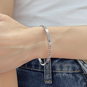 Close-up of geometric faceted silver bracelet on wrist for a modern stylish look