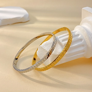 Elegant gold and silver titanium steel bracelets with geometric cube patterns for women