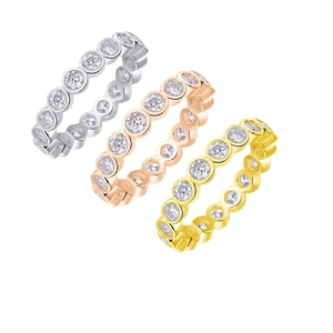 Three eternity rings in silver, rose gold, and gold plating with bezel-set stones