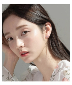 Close-up of S925 silver butterfly earrings with pink and white zircon on ear lobe