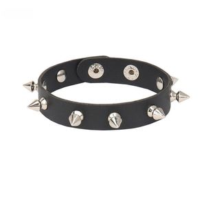 Detailed view of punk black PU leather cuff with silver metal spikes and snap closures