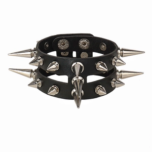 Detail view of double-row silver metal spikes on black leather punk rock bracelet