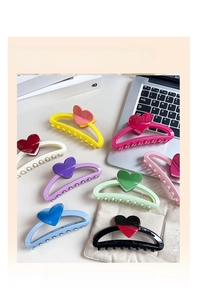 Close-up of candy-colored heart-shaped hair claw clips in a variety of macaron colors
