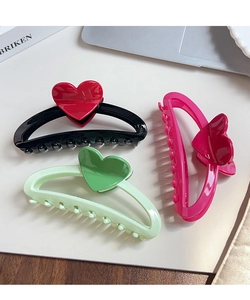 Three oversized heart-shaped hair claws in vibrant colors for long hair styling