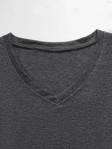Detailed close-up of a V-neck t-shirt neckline in dark grey marl fabric with fine stitching