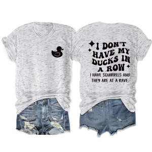 Detail view of the humorous typography and duck logo on a gray graphic t-shirt and denim shorts