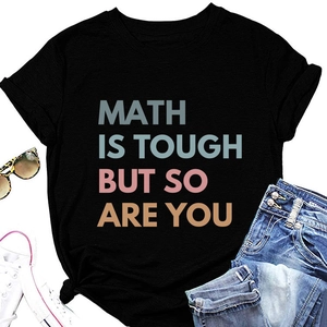 Flat lay of black T-shirt with Math Is Tough print styled with jeans and sneakers