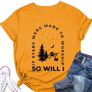 Detail of mustard yellow t-shirt featuring stars and mountain graphic with artistic text