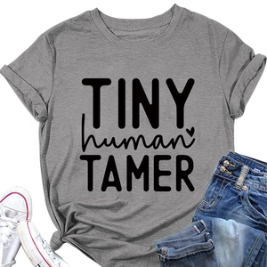Flat lay detail of grey cotton T-shirt featuring TINY HUMAN TAMER text and heart print