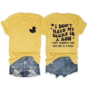 Detailed flat lay of yellow cotton t-shirt with funny duck print and denim shorts
