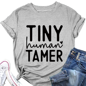 Flat lay of gray cotton T-shirt with TINY human TAMER print, jeans and shoes
