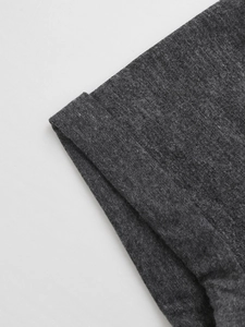 Detail of dark gray summer V-neck T-shirt showing sleeve cuff double-stitched hem texture