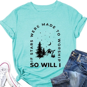 Flat lay of mint green cotton t-shirt with nature graphic and worship quote