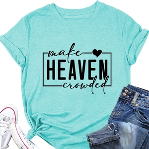 Flat lay of turquoise t-shirt with make heaven crowded text, sneakers, and jeans