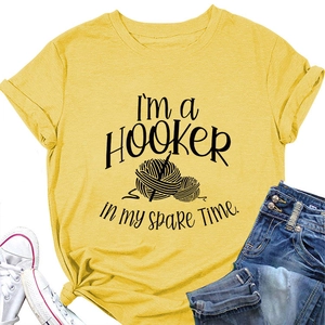 Detail view of yellow cotton t-shirt with I'm a Hooker crochet print and accessories