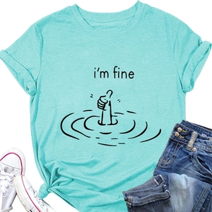 Close-up of mint green I'm Fine t-shirt with funny thumb graphic and denim outfit
