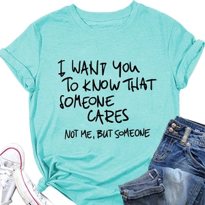Dettaglio della t-shirt in cotone verde menta con scritta nera a mano e stile casual